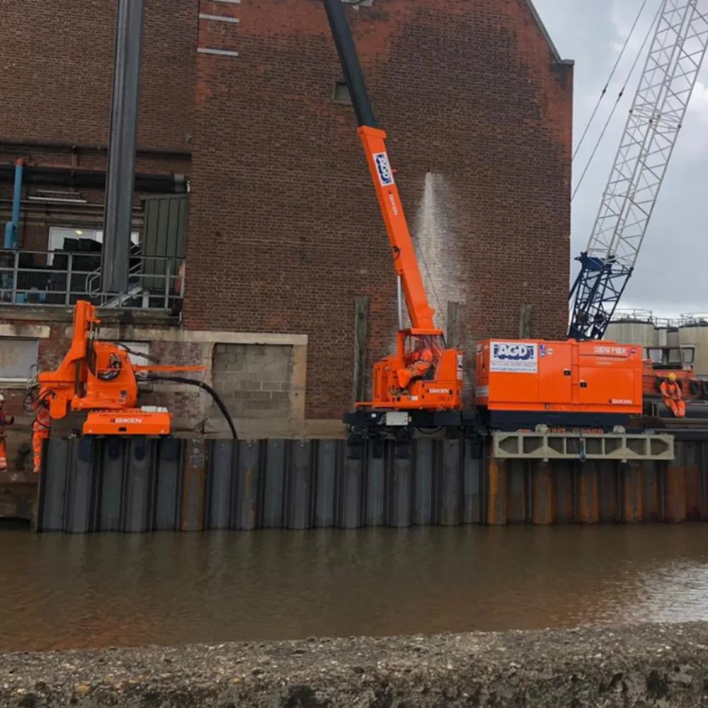 Giken silent piling equipment installing sheet piles beside the Hull river wall